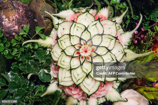 Carved watermelon is displayed during a fruit and vegetable carving competition in Bangkok on August 4, 2017. It is a royal tradition that has proved...