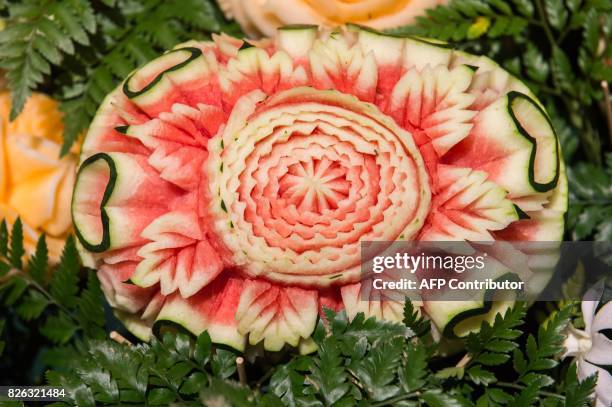 Carved watermelon is displayed during a fruit and vegetable carving competition in Bangkok on August 4, 2017. It is a royal tradition that has proved...