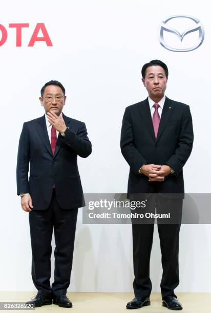 Toyota Motor Co. President Akio Toyoda, left, and Mazda Motor Co. President and CEO Masamichi Kogai, right, wait for a photo session at a joint press...