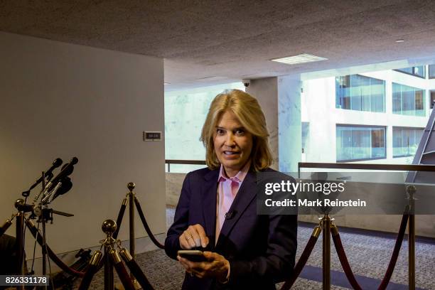 Portrait of American broadcast journalist Greta Van Susteren holds her smartphone outside room 216 of the Hart Senate Office Building, Washington DC,...