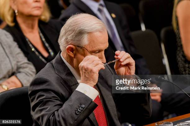 Attorney General Jeff Sessions adjusts his glasses as he testifies before the Senate Intelligence Committee, Washington DC, June 13, 2017.