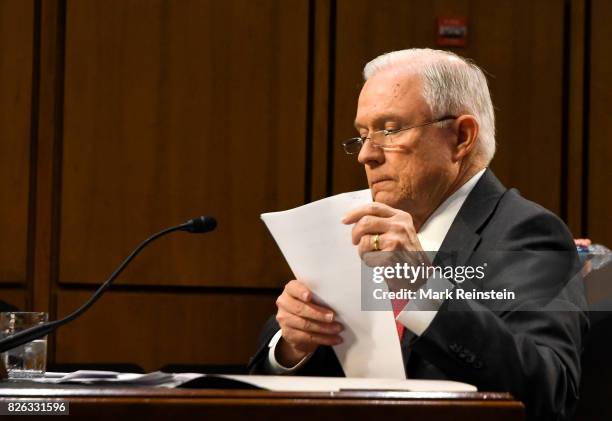 Attorney General Jeff Sessions reads from a document as testifies before the Senate Intelligence Committee, Washington DC, June 13, 2017.