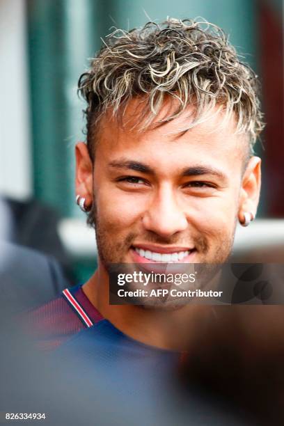 Brazilian superstar Neymar arrives to greet supporters during his official presentation at the Parc des Princes stadium on August 4, 2017 in Paris...