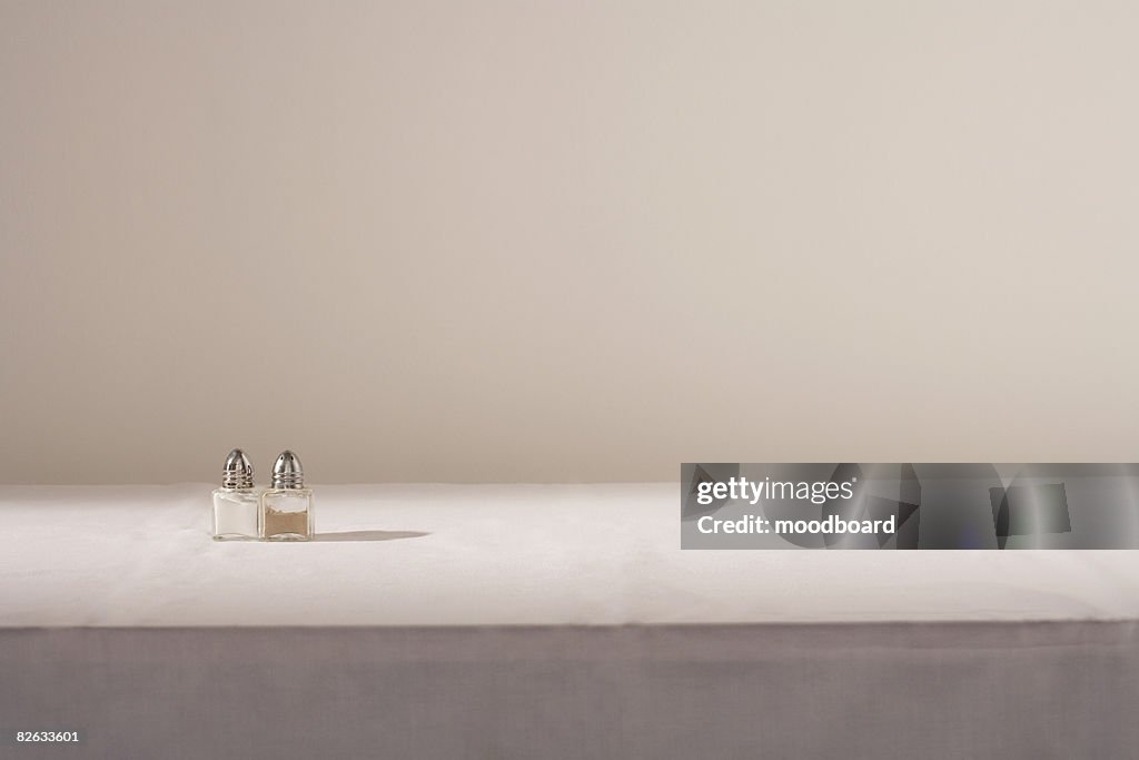 Salt and pepper shakers on table