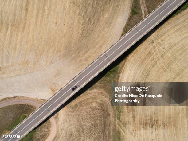 aerial drone view of car crossing road - car aerial view stock pictures, royalty-free photos & images