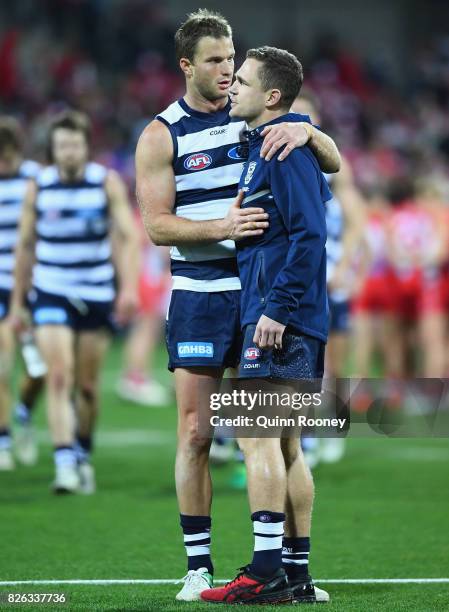 Lachie Henderson of the Cats talks to Joel Selwood after the game during the round 22 AFL match between the Geelong Cats and the Sydney Swans at...