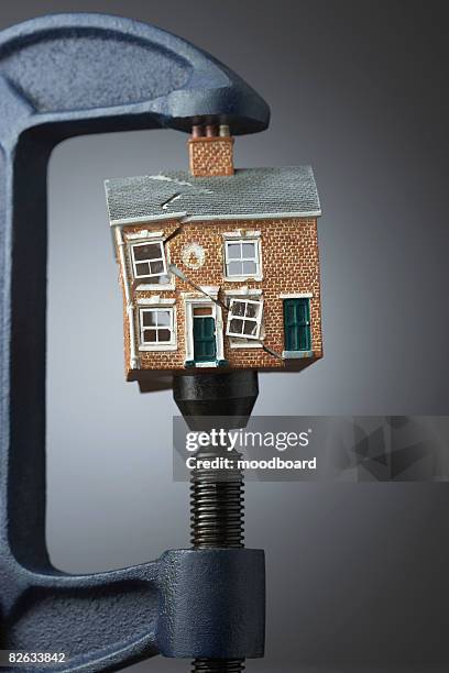 vice gripping small model house - damaged house stock pictures, royalty-free photos & images