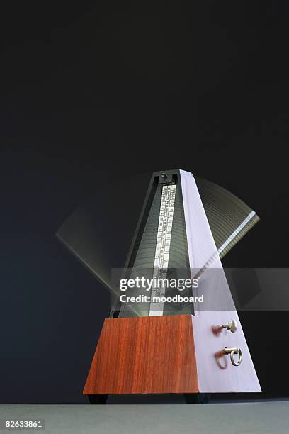 metronome in motion - metronom stock pictures, royalty-free photos & images