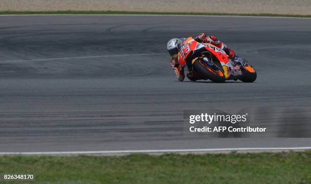 Repsol Honda Team's Spanish rider Marc Marquez rides in a free practice session prior to the Moto GP Czech Grand Prix race in Brno, Czech Republic,...