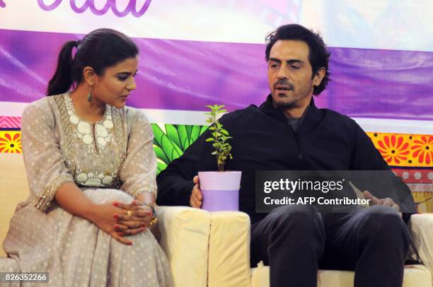 Indian Bollywood actor Arjun Rampal and South Indian actress Aishwarya Rajesh talk during a promotional event for the political crime drama Hindi...