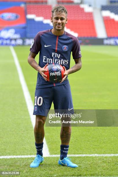 Neymar poses with his new jersey after a press conference with Paris Saint-Germain President Nasser Al-Khelaifi on August 4, 2017 in Paris, France....