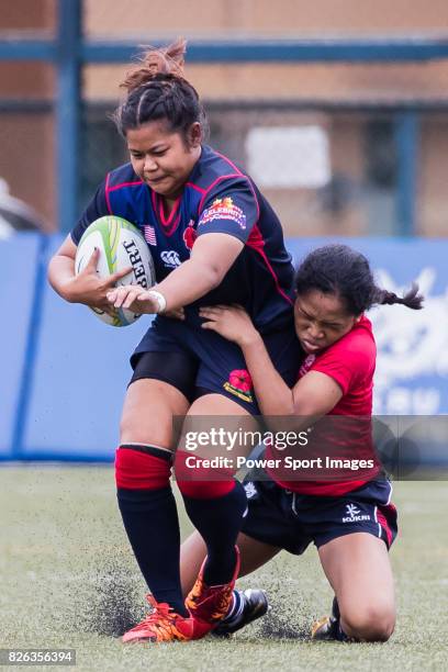 Fazzliana Chua Fui Teng of Malaysia is tackled by Sombo Sisay of Hong Kong during the Asia Rugby U20 Sevens 2017 at King's Park Sports Ground on...