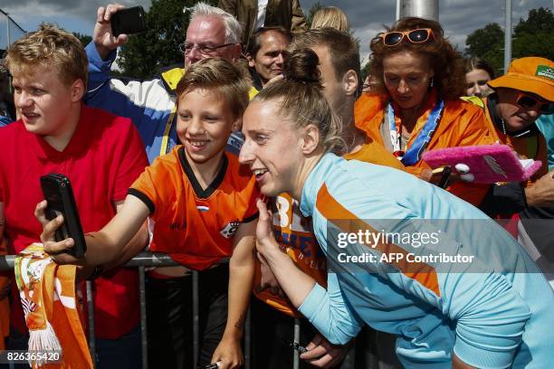 Netherland's goalkeeper Sari van Veenendaal poses for a "selfie" with fans before a football training session in De Lutte on August 4, 2017. The...