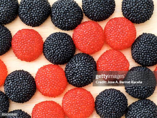 full frame of a background of soft fruit shaped candies (strawberry). - licorice stock pictures, royalty-free photos & images