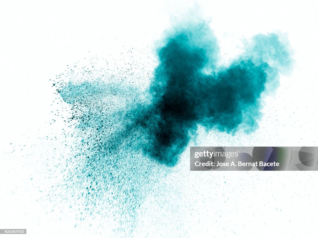 Forms and textures of an explosion of a powder of color blue on a  white background