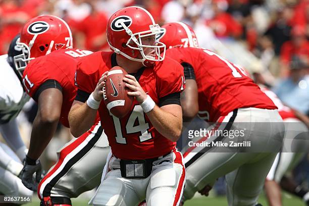 Quarterback Joe Cox of the Georgia Bulldogs takes a snap and looks to hand the ball off during the game against the Georgia Southern Eagles at...
