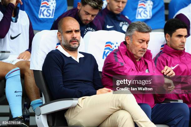 Josep Guardiola, Manager of Manchester City looks on prior to a Pre Season Friendly between Manchester City and West Ham United at the...