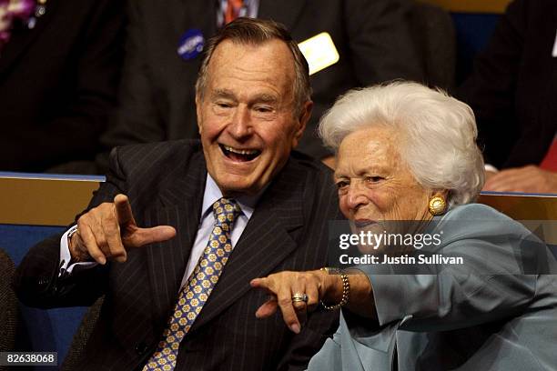 Former President George H.W. Bush and former first lady Barbara Bush point from their seats on day two of the Republican National Convention at the...
