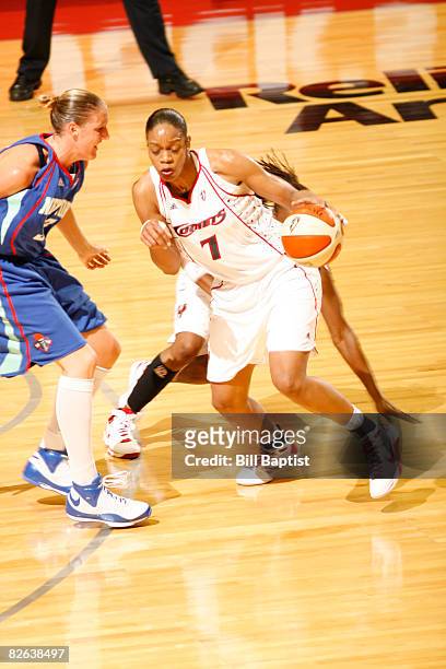 Tina Thompson of the Houston Comets drives the ball past Cathrine Kraayeveld of the New York Liberty at Reliant Arena on September 2, 2008 in...