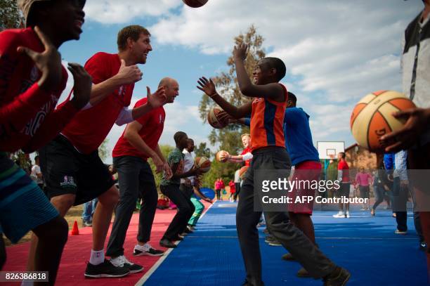 Players from various countries interact with children during a basketball clinic practice on the eve of the NBA Africa Game 2017 basketball match...