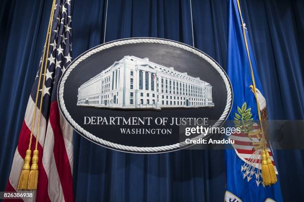 The Department of Justice logo hangs as the backdrop before a press conference held by Attorney General Jeff Sessions on leaks of classified material...