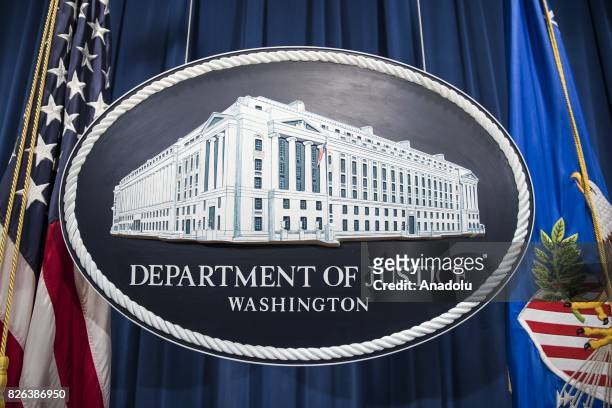 The Department of Justice logo hangs as the backdrop before a press conference held by Attorney General Jeff Sessions on leaks of classified material...