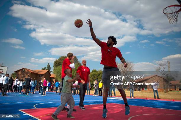 Cameroonian born NBA player Joel Embiid of the Philadelphia 76ers and other NBA players from different countries interact with children during a...