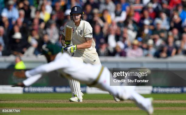 England batsman Ben Stokes drives a ball to the boundary despite the dive of Temba Bavuma during day one of the 4th Investec Test match between...