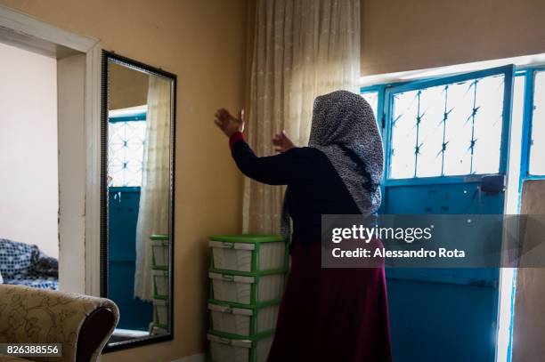 June 2015 - Ergani, Turkey. Hanim Kaya mother of Mutlu Kaya enters accompanied by the older daughter Sevil Denizhan for the first time in the house...