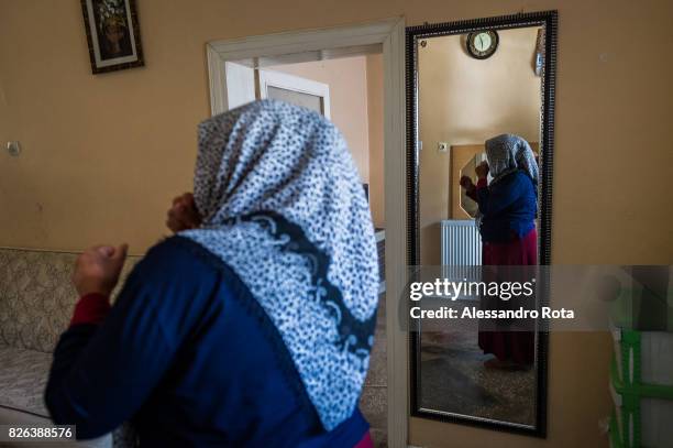 June 2015 - Ergani, Turkey. Hanim Kaya mother of Mutlu Kaya enters accompanied by the older daughter Sevil Denizhan for the first time in the house...