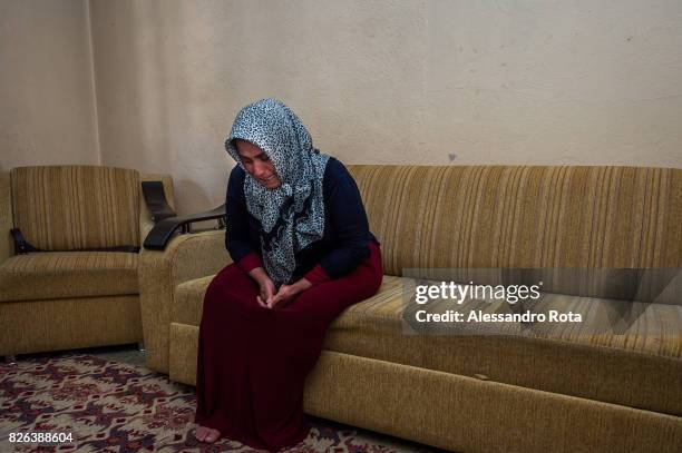 June 2015 - Ergani, Turkey. Hanim Kaya mother of Mutlu Kaya remembers moments of joy with her daughter in the house where Mutlu was shot in the head...