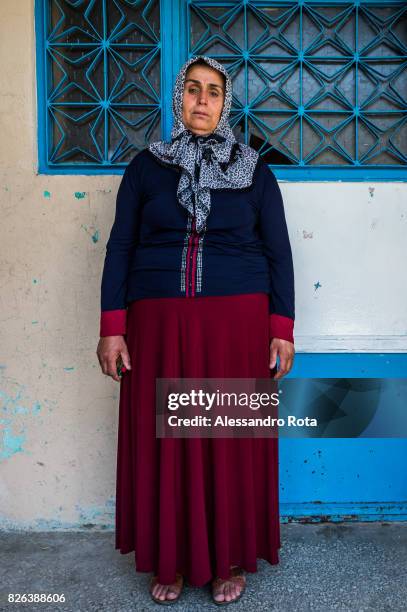 June 2015 - Ergani, Turkey. Hanim Kaya mother of Mutlu Kaya poses for a portrait outside the house where Mutlu was shot in the head on the night of...