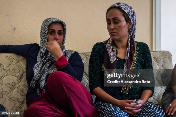 June 2015 - Ergani, Turkey. Hanim Kaya mother of Mutlu Kaya remembers moments of joy with her older daughter Sevil Denizhan in the house where Mutlu...