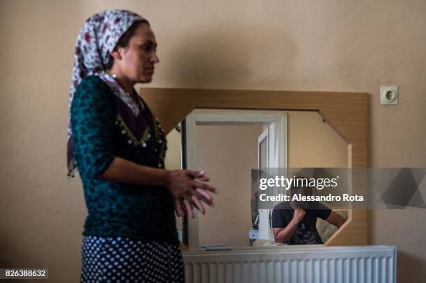 June 2015 - Ergani, Turkey. Sevil Denizhan sister of Mutlu Kaya remembers moments of joy with her younger sister in the house where Mutlu was shot in...