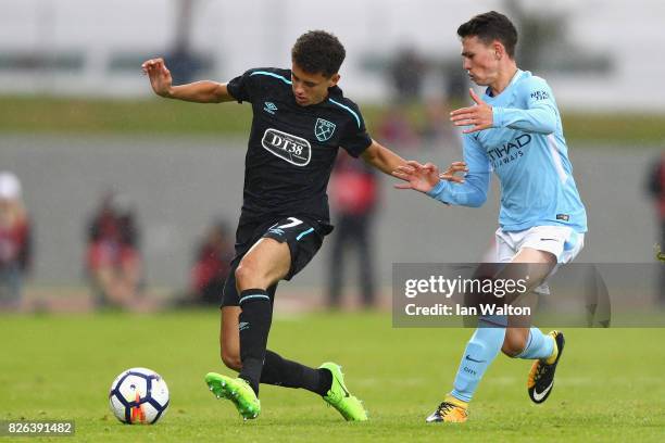Nathan Holland of West Ham United and Phil Foden of Manchester City battle for possession during a Pre Season Friendly between Manchester City and...