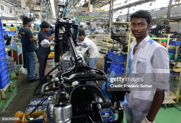 Employees stand among Royal Enfield Motors Ltd. Motorcycles on the production line at the company's manufacturing facility in Chennai on January 20,...