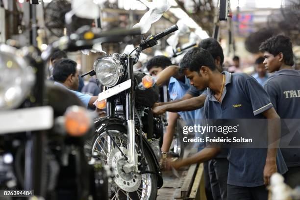 Employees stand among Royal Enfield Motors Ltd. Motorcycles on the production line at the company's manufacturing facility in Chennai on January 20,...