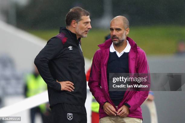 Slaven Bilic, Manager of West Ham United and Josep Guardiola, Manager of Manchester City speak after a Pre Season Friendly between Manchester City...