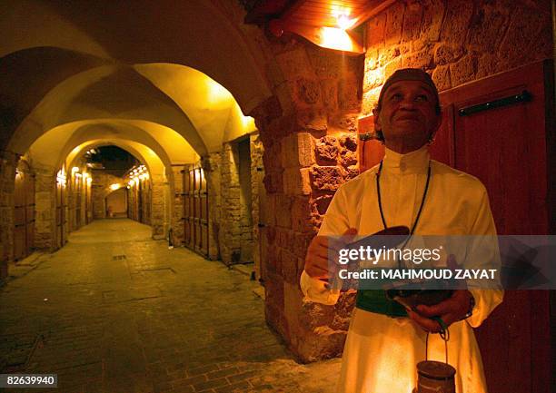 Lebanese 'Musaharati' Mohammed Fanas wakes up observant Muslims for their overnight 'suhur' meal before the day's fast in Sidon's Old City in south...