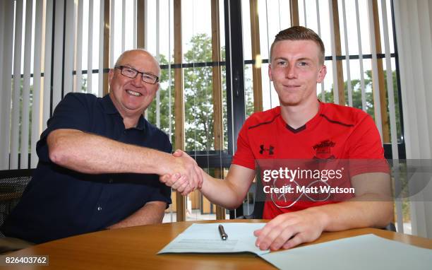 Southampton FC's Matt Targett signs a new five year contract with the club, pictured with Vice Chairman Les Reed at the Staplewood Campus on August...