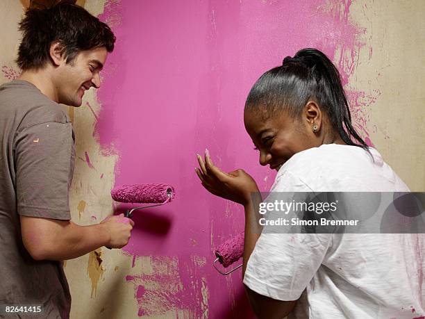 couple painting, laughing - home improvement stock pictures, royalty-free photos & images