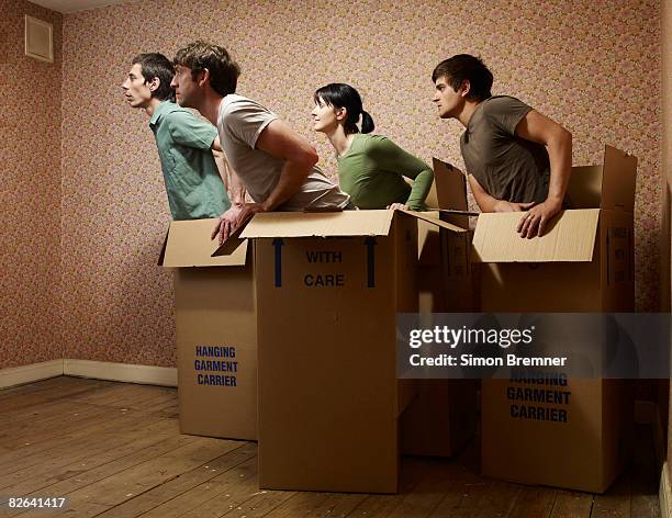 people in boxes facing same direction - repetition stock pictures, royalty-free photos & images