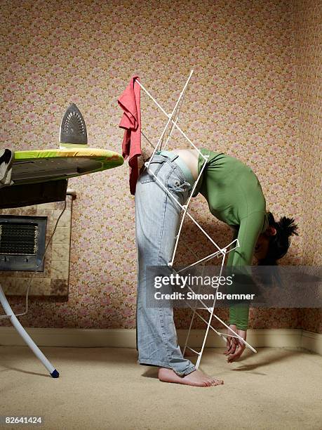 woman trapped in airer - funny situation woman imagens e fotografias de stock