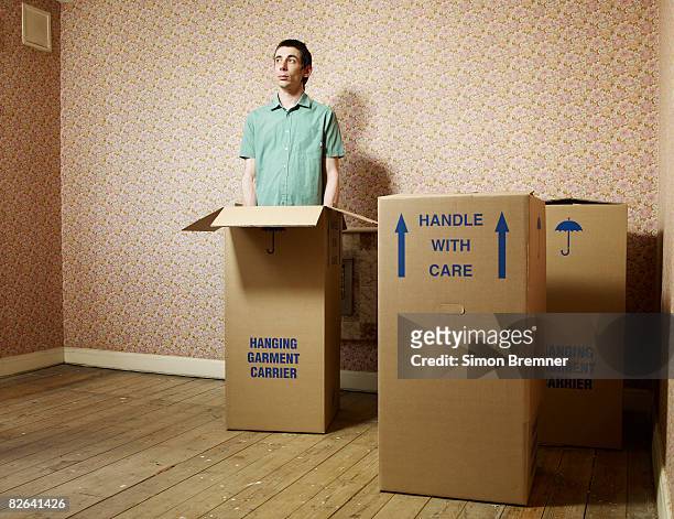 man standing in box - eccentrico foto e immagini stock