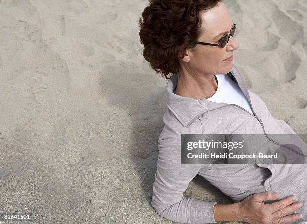 woman laid on sand  - heidi coppock beard stock-fotos und bilder