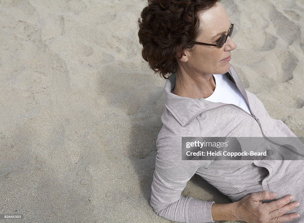 Woman laid on sand 