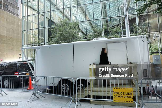 Small trailer sits along a side street under a large antenna and a newly built wooden walkway outside of Trump Tower on August 4, 2017 in New York...