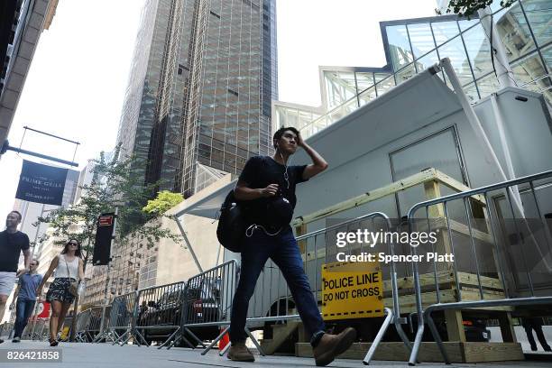 Small trailer sits along a side street under a large antenna and a newly built wooden walkway outside of Trump Tower on August 4, 2017 in New York...