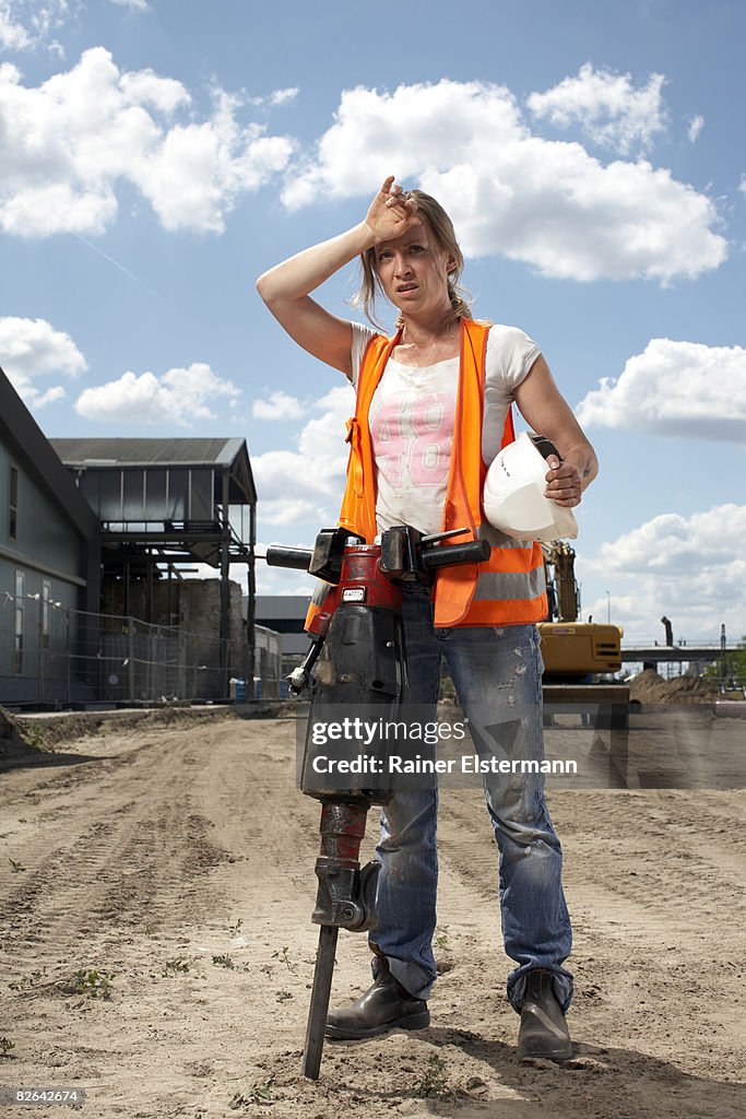 Female construction worker with machinery