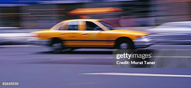 yellow cab in motion - yellow taxi stock pictures, royalty-free photos & images